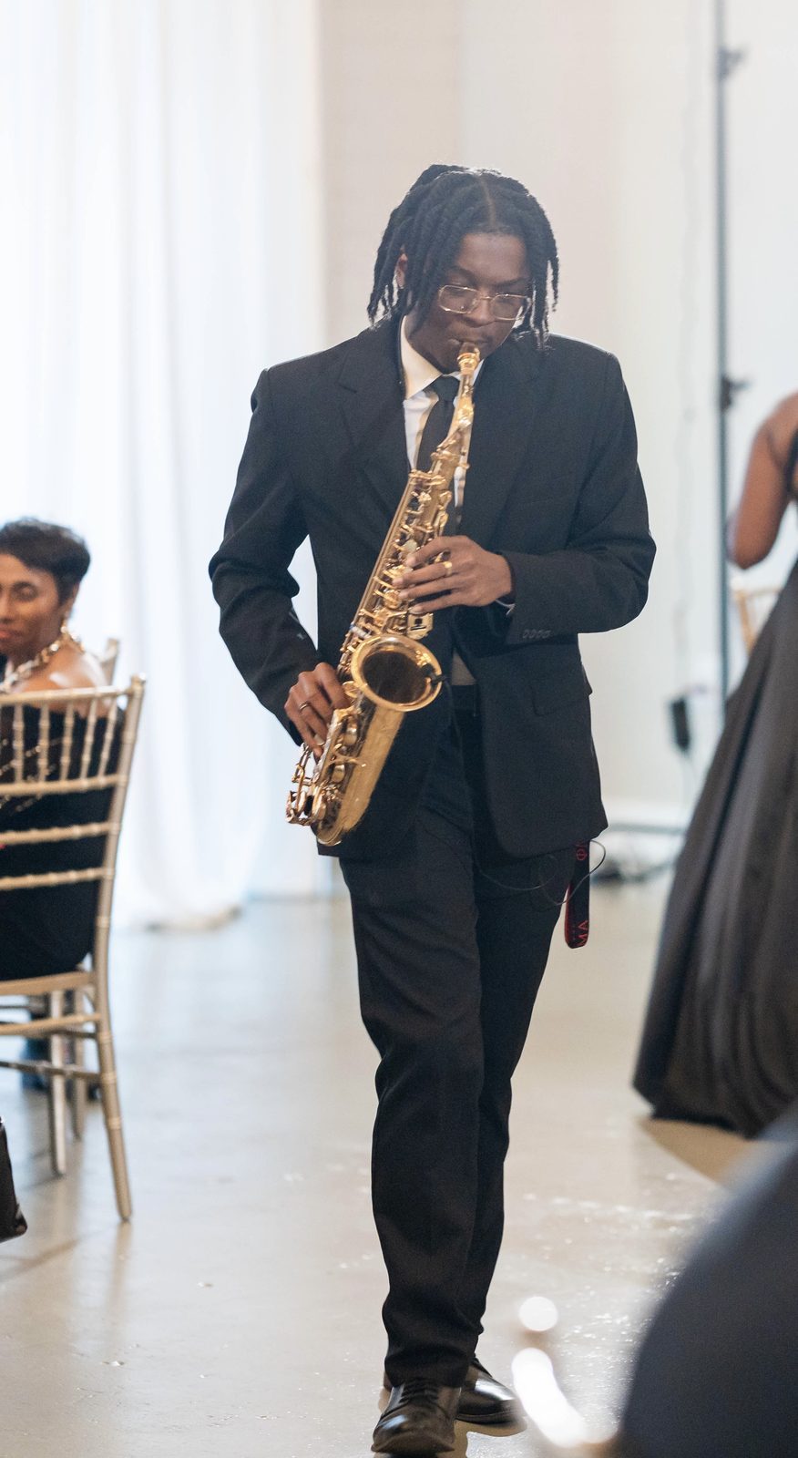 Ry Lo playing saxophone at a reception
